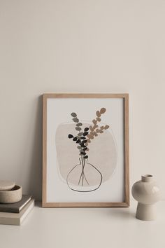 a vase with flowers in it sitting on a shelf next to a small white vase