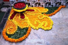 a large flower arrangement on the ground in front of other flowers