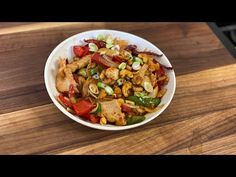 a white bowl filled with food on top of a wooden table