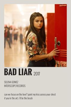 a woman standing in front of a red locker with the words bad liar written on it