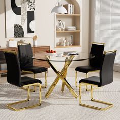 a glass dining table with black chairs around it and a white rug on the floor