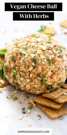 vegan cheese ball with herbs on top of crackers