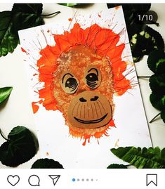 a painting of a monkey with orange paint on it's face surrounded by green leaves