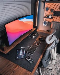 a computer monitor sitting on top of a wooden desk next to a keyboard and mouse