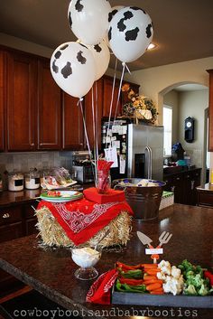 some balloons that are on top of a counter in a kitchen with other food items