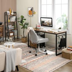 a living room with a computer desk and chair