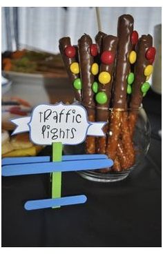 a table topped with lots of chocolate covered pretzels