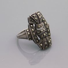 "Stunning antique marcasite and sterling art deco era ring. Design brings to mind ribbons gathered in the middle. Marcasite are the old style bead set. Ring measures about 7/8 inch front to back and measures a US size 6 1/2. Ring is marked. \"sterling\" and presents in very good antique condition. Ring band is slightly out of round in the picture but I have corrected that so it is rounded correctly. Beautiful and classic antique sterling art deco ring for your collection. Thank you for shopping Daisy Jewelry, Purple Daisy, Marcasite Ring, Vintage Owl, Ring Antique, Bead Set, Bird Jewelry, Set Ring, Deco Ring