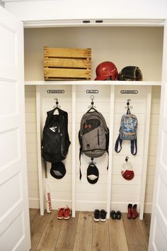 a white coat rack filled with backpacks and shoes