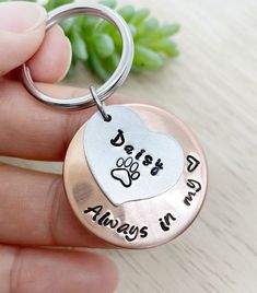 a person holding a metal keychain that says, best friend always in my heart