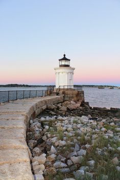 a light house sitting on top of a rocky shore