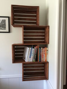 a book shelf made out of wooden slats with books on top and below it