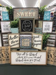 several wooden signs are stacked on top of each other in front of a store display