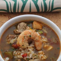 a bowl of seafood and rice soup on a table