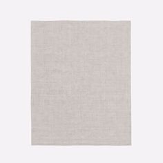 a white square rug on a gray background