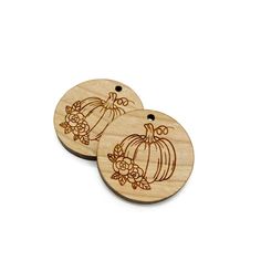 two wooden tags with pumpkins and flowers on them