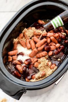 a crock pot filled with beans and spices