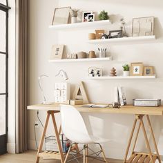 a desk with two white chairs in front of a window and shelves on the wall