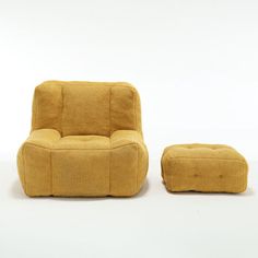 a yellow chair and footstool sitting next to each other on a white surface