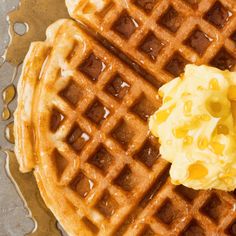 two waffles with butter and syrup on them sitting next to eachother