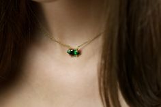 Transform your look with this delicately crafted 18k Gold Marquise Cut Emerald Pendant Necklace. Featuring a 6x12mm green emerald in a horizontal setting, this pendant captures the essence of elegance. Perfect for women or girls, this necklace makes a thoughtful May birthstone gift. Emeralds are traditionally considered stones of successful love and renewal, bringing freshness and vitality to the spirit. Marquise Emerald 6x12mm Gemstone Horizontal Setting Handmade Charm May Birthstone Product specifications Jewelry Information Metal stamp 14K Metal Gold Filled Gem Type Emerald Setting prong Resizable No Stone Information Stone shape Marquise Shape Minimum color Green Cut Checkerboard Cut Stone Creation Method Simulated Stone Treatment Method Not Treated Stone Length 6 millimeters Stone Wid Elegant Emerald Pendant Necklace With Bezel Setting, Green Emerald Pendant Necklace With Bezel Setting, Dainty Emerald Necklace For Formal Occasions, Dainty Green Emerald Necklace For Formal Occasions, Elegant Oval Pendant Emerald Necklace, Elegant Oval Emerald Pendant Necklace, Emerald Pendant Necklace, Emerald Necklace Pendant, Gothic Anime