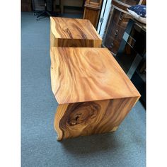 two wooden tables sitting on top of a carpeted floor