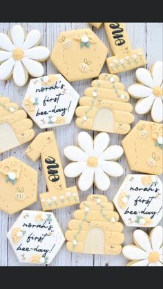 decorated cookies with happy birthday written on them and flowers in the middle, sitting on a wooden table