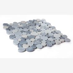 a pile of grey and white rocks on a white background