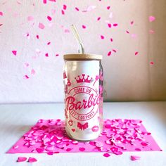 a pink confetti filled can with a straw in it