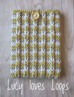 a crocheted bag with a button on the front that says lacy loves loops