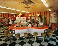 an orange and white checkered floor in a restaurant with lots of counter top space