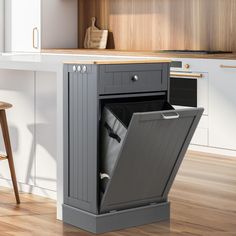 a kitchen with an open trash can in it