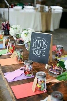 the table is set up with candy jars and place cards for guests to write their names