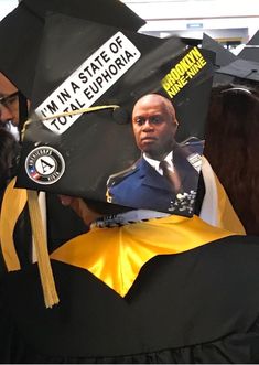 a man in a graduation cap with an image of him on it's back