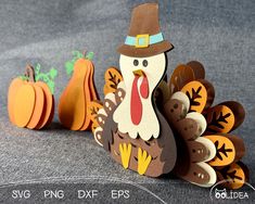 a paper turkey and some pumpkins on a table