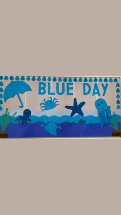 a blue day sign with an octopus, starfish and jellyfish under an umbrella