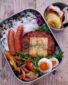 a lunch box with rice, meat and vegetables