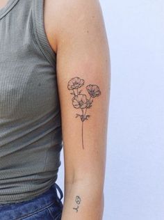 a woman with a flower tattoo on her arm