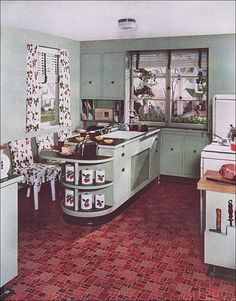 an old fashioned kitchen with green cabinets and red tile flooring