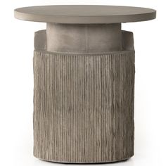 a round table with a circular top and pleated design on the base, sitting in front of a white background