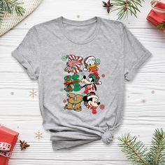 Disney Christmas Pajamas, Disney Christmas Holiday Tops, Disney Christmas Holiday Top, Christmas Disney Holiday Top, Disney Cotton Christmas Tops, Disney Christmas Cotton Top, Disney Graphic Print T-shirt For Holiday, Disney Cotton T-shirt For Winter, Casual Christmas Tops With Character Print