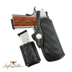 a black leather holster with a wooden handle and laser engraved on the inside of it