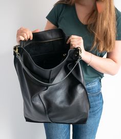 Oversize style Leather handbag made of 100% high quality soft cattle leather. LARGE and very roomy LEATHER Hobo BAG Fits all size laptops, room for a couple of books, wallet Brass Color Hardware adds style to the shoulder bag. This Leather Hobo handbag is very big and roomy! Top of the shopper bag has zipper closure - keeps your important stuff safe. Inside the shopper bag there is a pocket with zipper - for your keys, lip gloss, iPhone, glasses The bag can be worn on the shoulder. DIMENSIONS: H Large Shopper Bag, Oversize Style, Mulberry Bag, Large Hobo Bag, Leather Hobo Handbags, Black Leather Handbag, Oversize Fashion, Black Purse, Beautiful Handbags