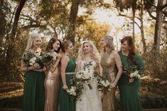 a group of women standing next to each other holding bouquets in their hands and smiling