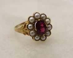 14k yellow gold estate wonderful almandine garnet ring with pearls. size 6 and in great shape. 2.2 grams. 12.4mm wide. center stone is 6.3mm by 4.5mm. beautiful. the almandine garnet is very red in color. mark is there but fadded acid tests for 14k. will come in nice ring box. Medieval Engagement Rings, Garnet Wedding Rings, Pearl Anniversary, Garnet Wedding, Romantic Rings, Almandine Garnet, Diy Jewelry Unique, Indie Jewelry, Vintage Charm Bracelet