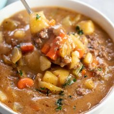 a white bowl filled with stew and vegetables