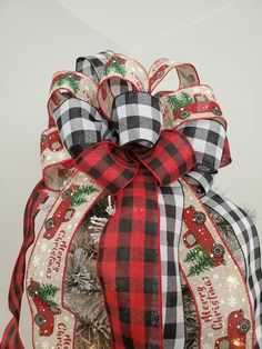 a christmas tree with red, black and white ribbon