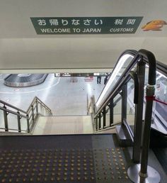 an escalator with a sign that says welcome to japan customs