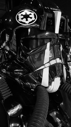 a star wars helmet on display in a black and white photo