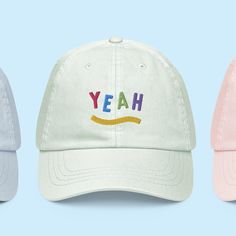 The Yeah Hat has a low profile with an adjustable strap and curved visor. * Embroidered yeah motif to the front * 100% chino cotton twill * Unstructured, 6-panel, low-profile * 6 embroidered eyelets * 3 ⅛" (7.6 cm) crown * Adjustable strap with antique buckle * Head circumference: 20 ½″-21 ⅝″ (50.8 cm-53.3 cm) Fun Cotton Hats For Streetwear, Fun Cotton Visor Hat, Fun Cotton Snapback Trucker Hat, Trendy Six-panel Hat With Embroidered Logo, Fun Cotton Trucker Hat, Fun Cotton Baseball Cap With Letter Print, Fun Cotton Snapback Baseball Cap, Fun Cotton Hat With Curved Bill, Fun Cotton Letter Print Baseball Cap